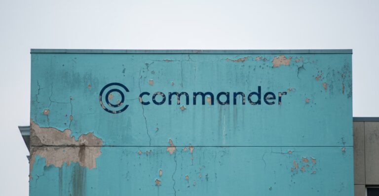 Dilapidated building with the Commander logo.